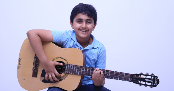 Child Learning to Play an Instrument in a School in Gurgaon