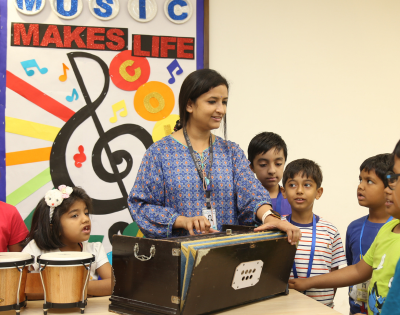Teacher Guiding Students in a School Music Session