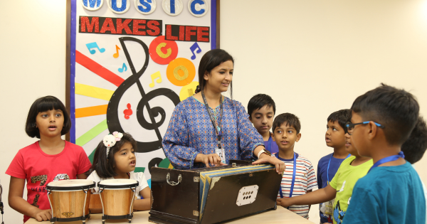 Teacher Guiding Students in a School Music Session