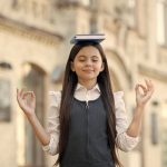 calm mind little child meditation outdoors small girl mudra hands holding book head meditation mental balance meditation course beginner school education best therapy (1)